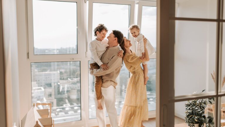 Parents carrying their young children indoors