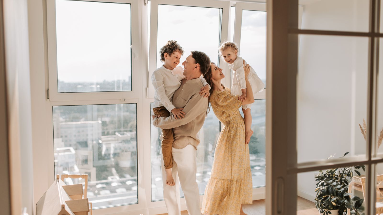 Parents carrying their young children indoors