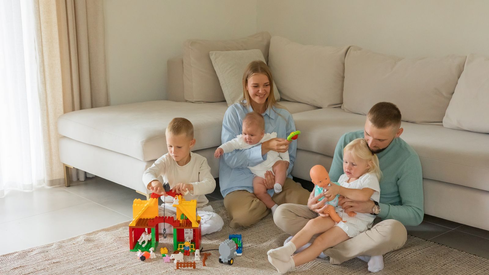 Family playing with toys in a living room