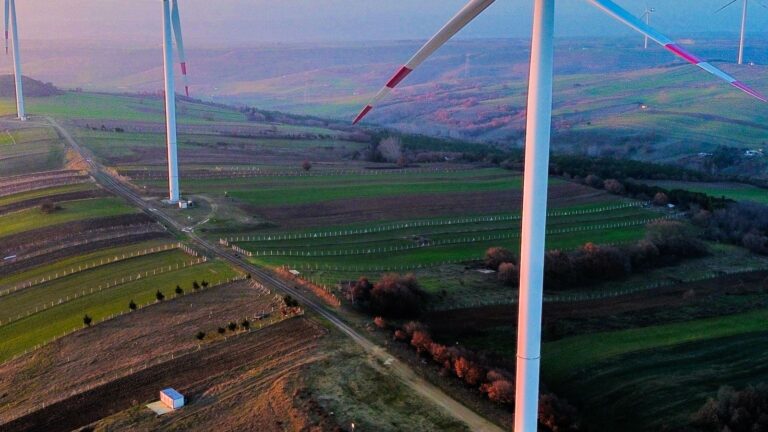 Aerial view of wind turbines at sunset