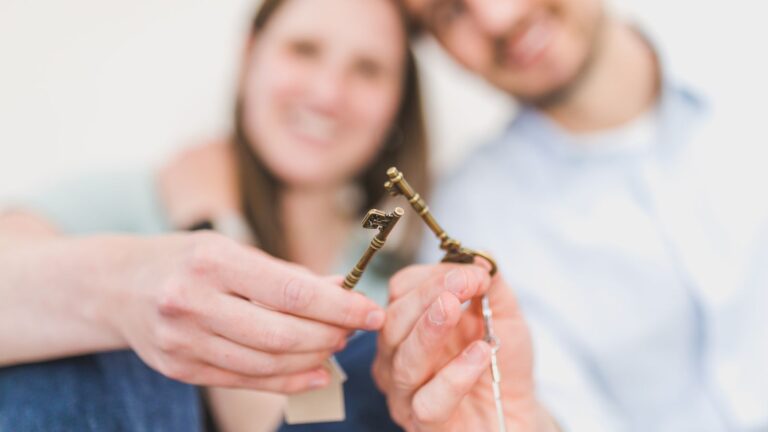 Couple holding the keys to their first home