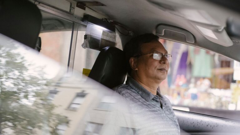 Rideshare driver at the wheel of a car