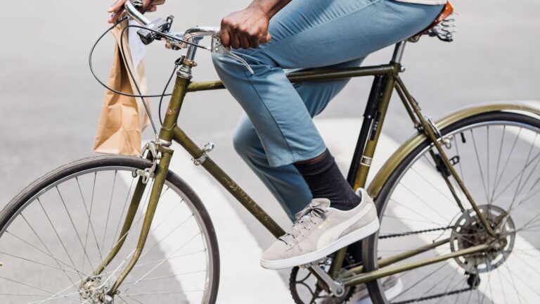 Courier cycling with a food delivery bag