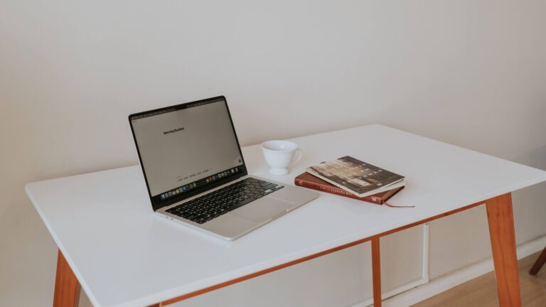 Laptop and notebook on a tidy home office desk