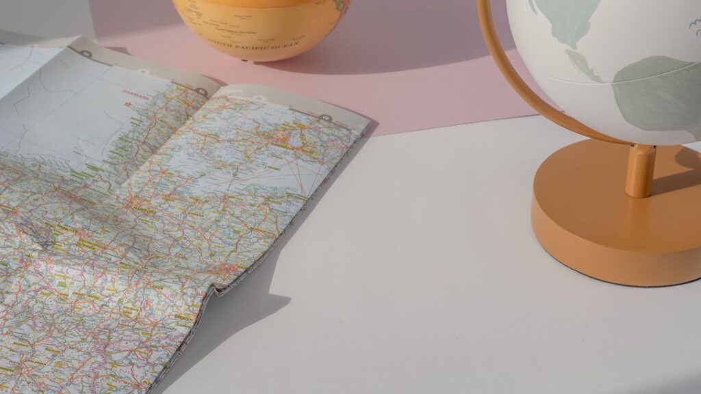 Globes and a world map laid out on a table
